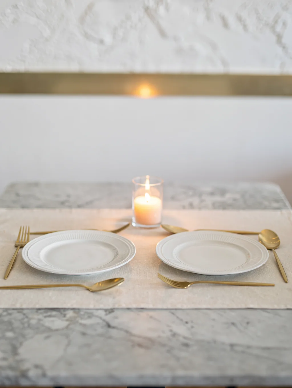 Artisanal ceramic tableware on a linen-covered table